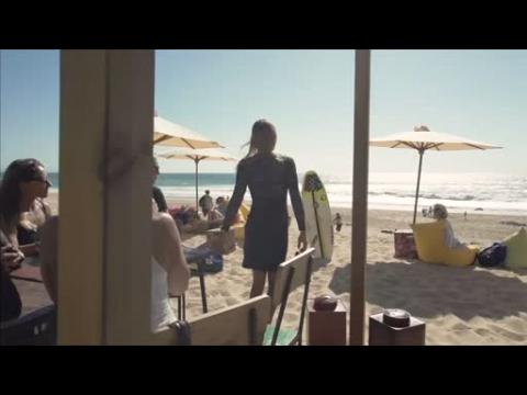 Surfer rides the waves in style - wearing high heels