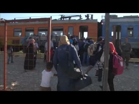 Migrants board north-bound train from Macedonia