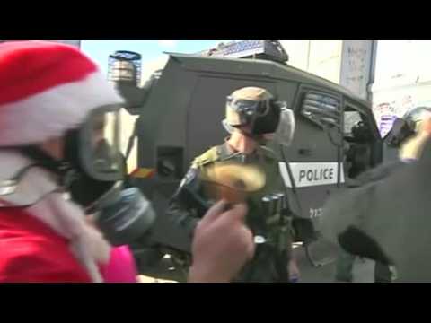 Santa-suited protesters clash with Israeli troops