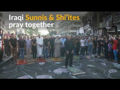 Iraqi Sunnis and Shi'ites pray together in a show of unity