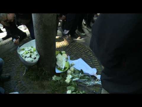 Paris police officers lay flowers for their deceased colleague