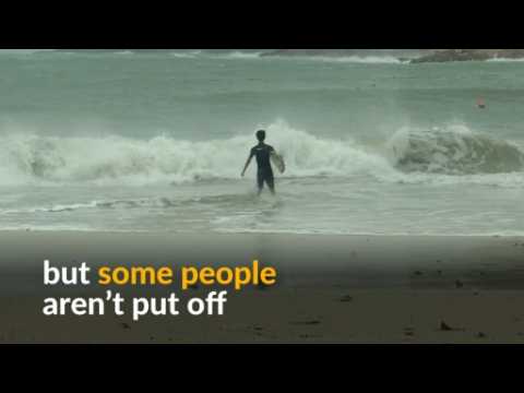 Surfers ride typhoon waves in Hong Kong