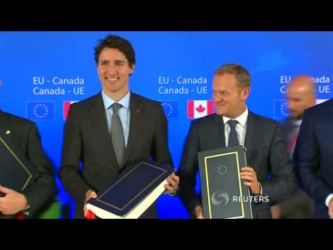EU, Canada sign free trade deal but battle not over