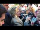 Hillary Clinton greets supporters after casting her vote