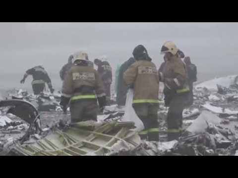 Emergency workers sift through remains of crashed plane