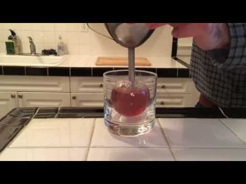 A online video tutorial showing how to make cocktail in an ice ball
