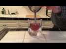 A online video tutorial showing how to make cocktail in an ice ball