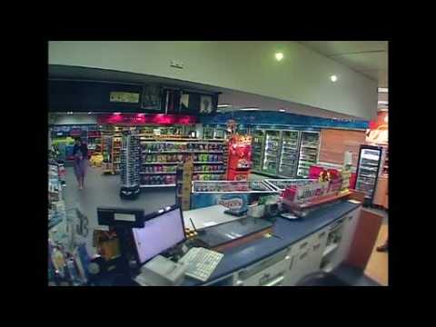 Surveillance camera shows car ploughing into Sydney service station narrowly missing a woman inside