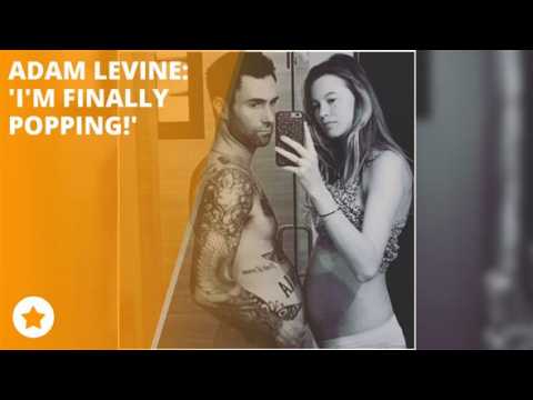 Adam Levine proudly shows off his baby bump!