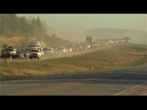 Convoy leads Canada fire evacuees through burning city to safety