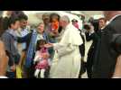 Pope returns with 12 refugees after visit to Greek camp