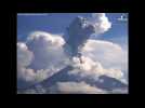Erupting Mexico volcano fills blue sky with dark ash