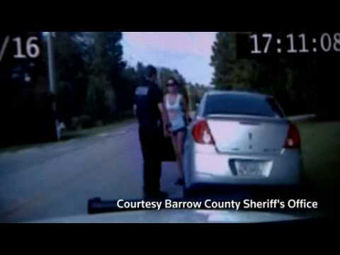 Video shows woman accused of running over officer's legs