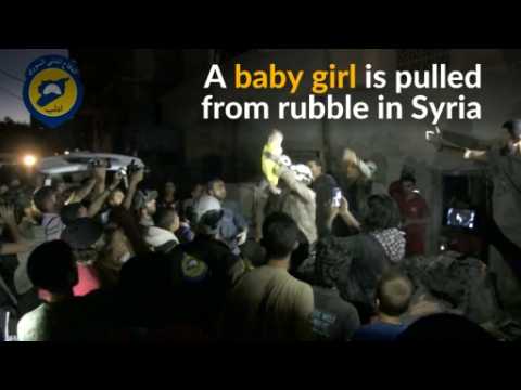Syrian rescue worker breaks down while cradling baby girl pulled from rubble