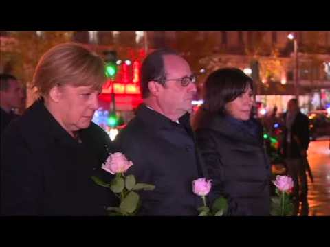 Hollande, Merkel lay flowers at vigil for Paris attack victims