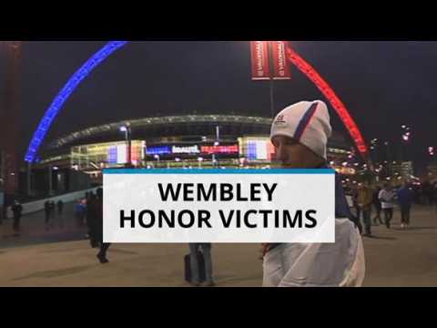 English, French fans pay tribute to victims at Wembley