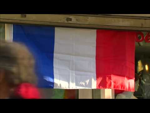 Paris residents fly national flags in solidarity after attacks
