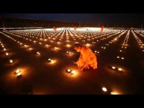 Thai Buddhist temple lights 330,000 candles set Guinness World record on Earth Day in Thailand