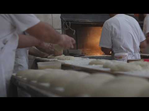 Bakers bake 'pitalka' bread during Ramadan in Kosovo