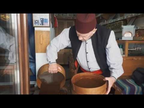 Grinding coffee with a mortar in Sarajevo, a tourist attraction in the city