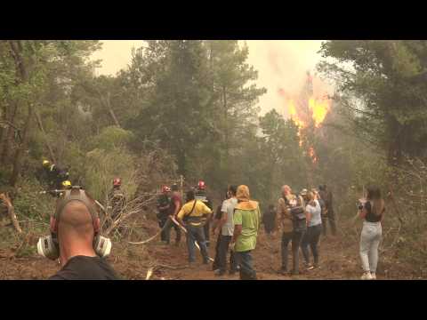 Fire burns as firefighters struggle to contain Greek fires