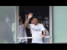 Football: Lionel Messi waves from airport window upon arrival in Paris
