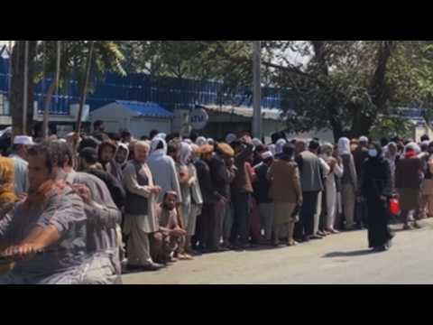 Thousands of Afghans congregate in front of banks to withdraw money from their accounts