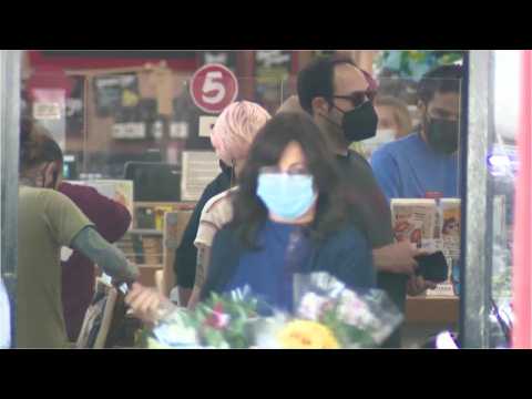 People in masks shopping at Trader Joes as grocery chain drops its mask requirement