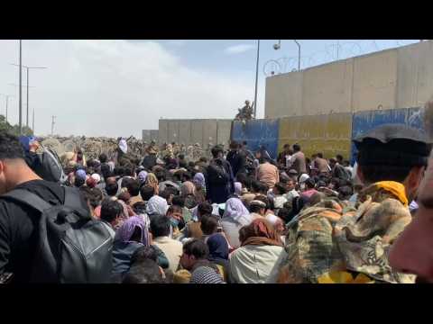 Desperate Afghans wait outside Kabul airport in hope of leaving