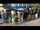 Afghans queue outside banks to withdraw cash from ATMs
