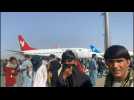 Desperate Afghans crowd Kabul airport apron to flee Taliban