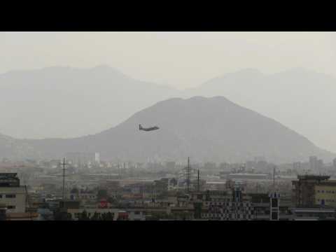 Airplanes land and take off at Kabul airport as evacuations continue