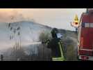 Italian firefighters battle coastal wildfires