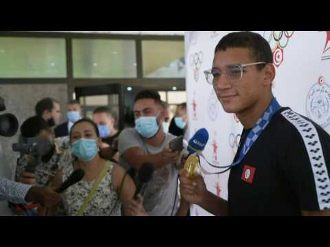 Tunisia's new Olympic king Ahmed Hafnaoui arrives in Tunis