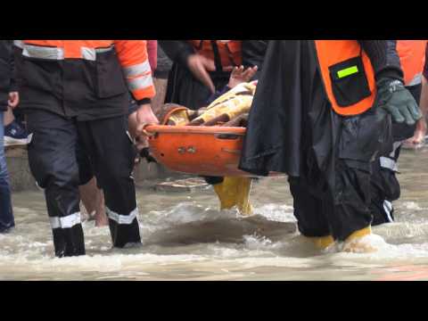Palestinian rescuers evacuate camp residents from flooded houses