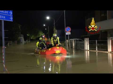 Italian fire brigade evacuate people by boat after deadly storms and flooding