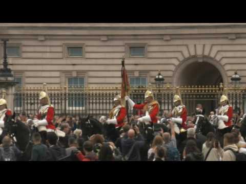 Members of King's Life Guards ride in front of Buckingham Palace following Queen's death