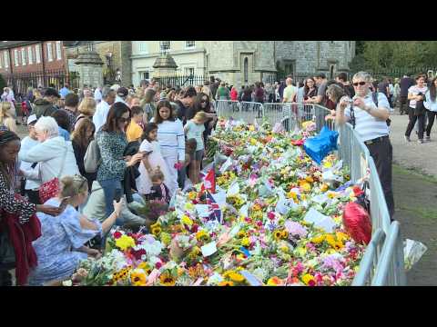 People place flowers for Queen Elizabeth II in Windsor