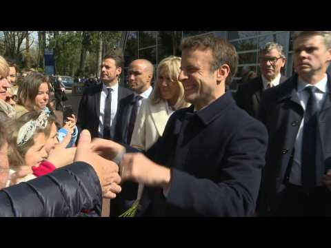Macron, wife Brigitte arrive to vote in first round of presidential election