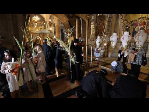 Orthodox Christians attend Palm Sunday mass in Jerusalem's Holy Sepulchre
