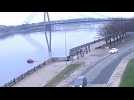 Unoccupied car rolls across road and into river in Riga