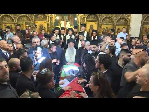 Palestinian mourners carry coffin of slain Al Jazeera journalist into Jerusalem church