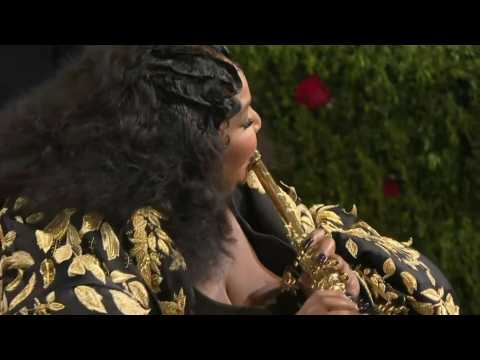 Lizzo plays the flute on the Met Gala red carpet