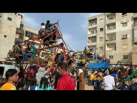 Syrians celebrate Eid al-Fitr at a makeshift amusement park