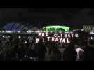 Nighttime climate protest on banks of Glasgow's River Clyde