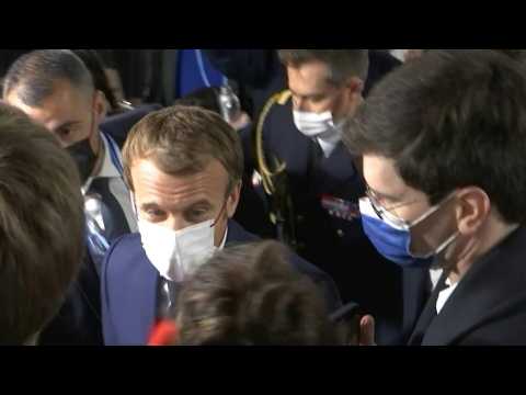 Emmanuel Macron walks through media scrum at COP26 conference centre