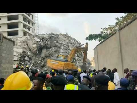 Excavator digs through rubble of collapsed Lagos high-rise in Nigeria