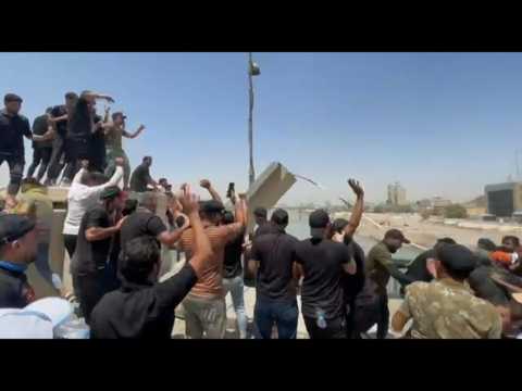 Supporters of Iraqi cleric Moqtada Sadr bring down concrete barriers leading to the "Green Zone"