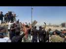 Supporters of Iraqi cleric Moqtada Sadr bring down concrete barriers leading to the "Green Zone"