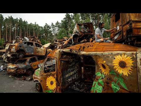 Flowers for Hope: artists paint sunflowers on destroyed vehicles in war-torn Irpin